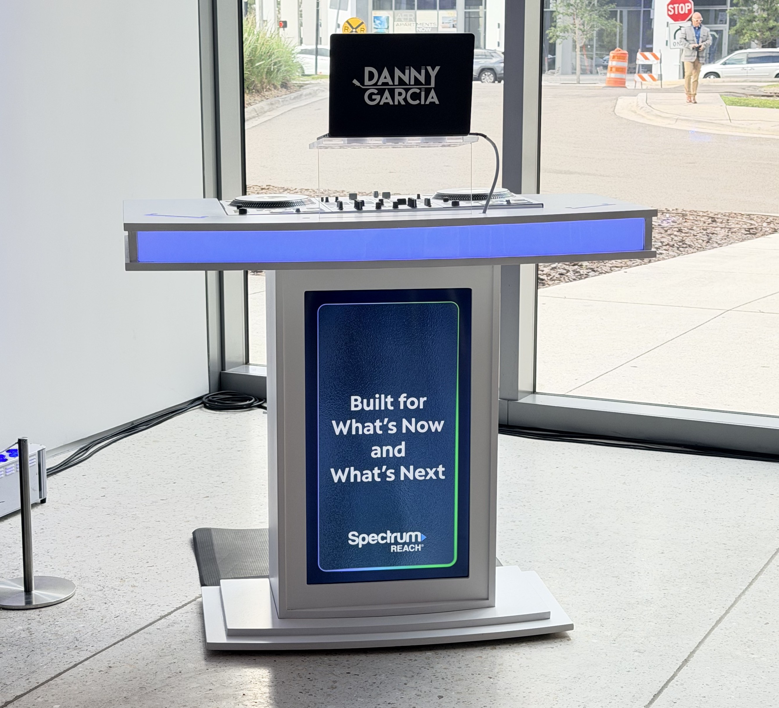 Branded DJ booth with digital screen at a corporate event