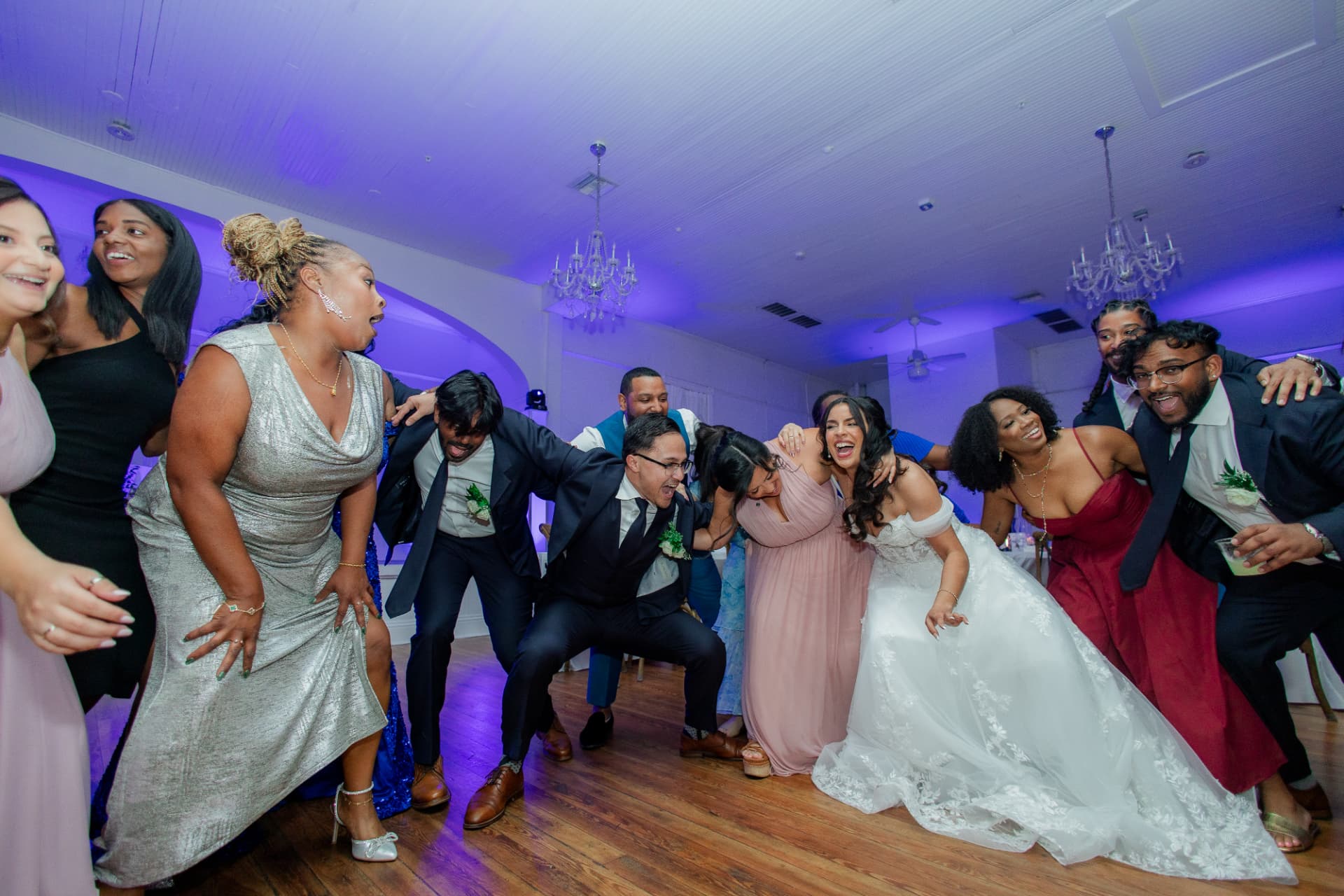 Wedding guests and couple dancing at a lively reception