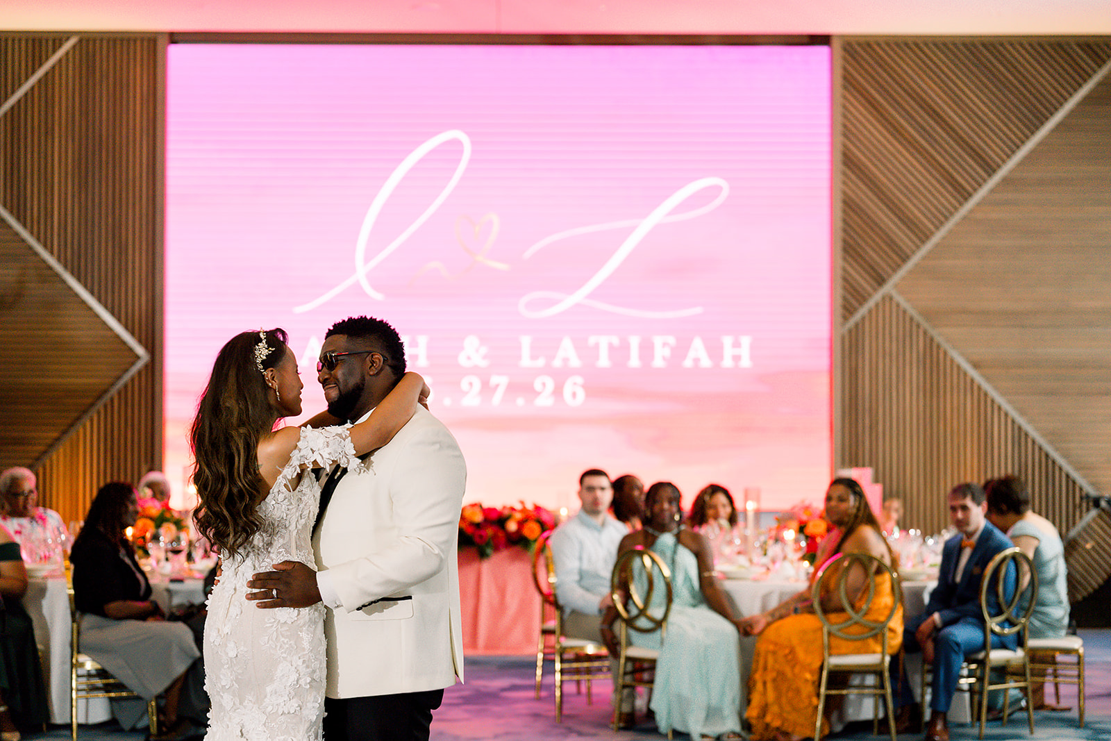 First dance in front of a custom LED monogram wall